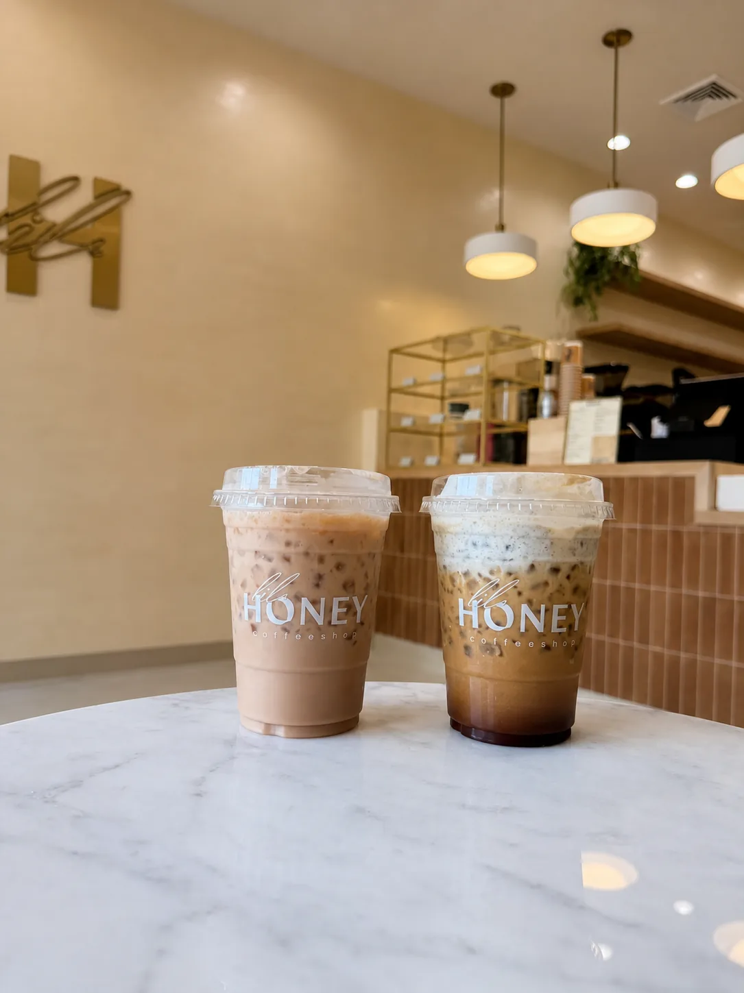 Two Lil Honey drinks inside the bright wood-and-cream Ridgewood shop