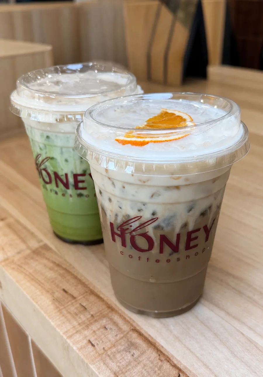 Two Lil Honey drinks topped with cold foam and orange
