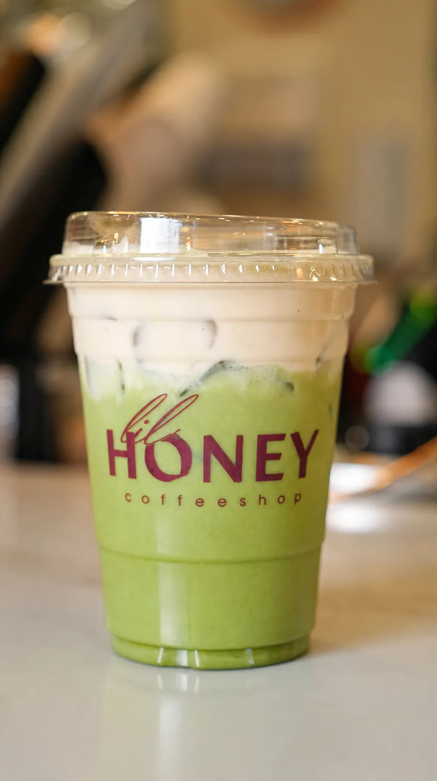 Bright green Lil Honey matcha latte with cold foam